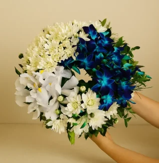 Blue and white sympathy wreath with chrysanthemums orchids and iris for funeral delivery Gold Coast