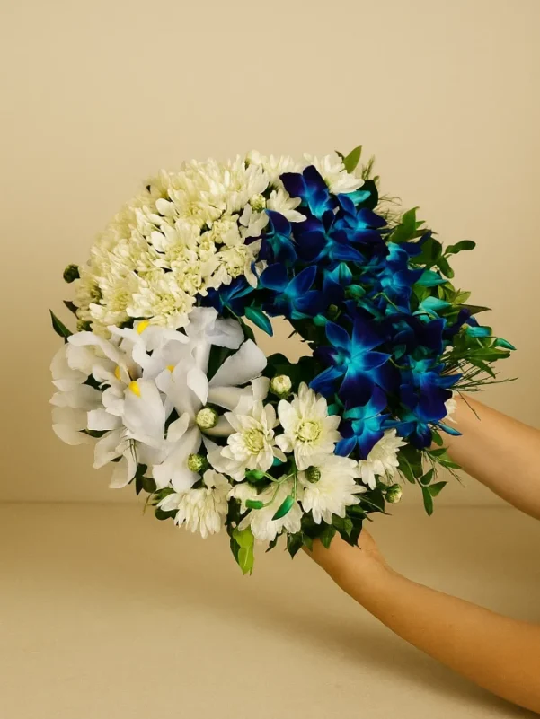 Blue and white sympathy wreath with chrysanthemums orchids and iris for funeral delivery Gold Coast