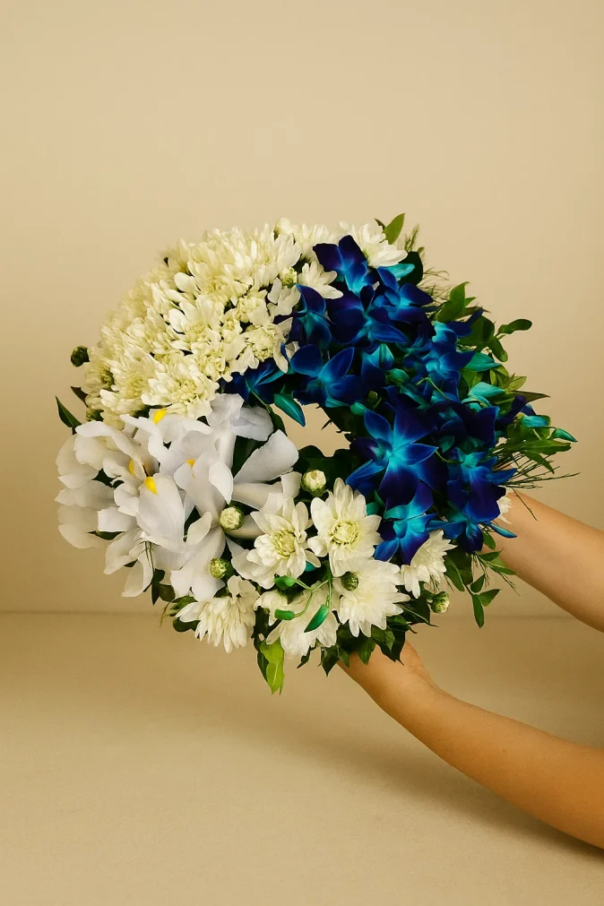 Blue and white sympathy wreath with chrysanthemums orchids and iris for funeral delivery Gold Coast