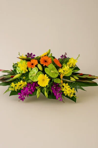 Flower centrepiece Gold Coast with bright colourful seasonal flowers in a low table arrangement