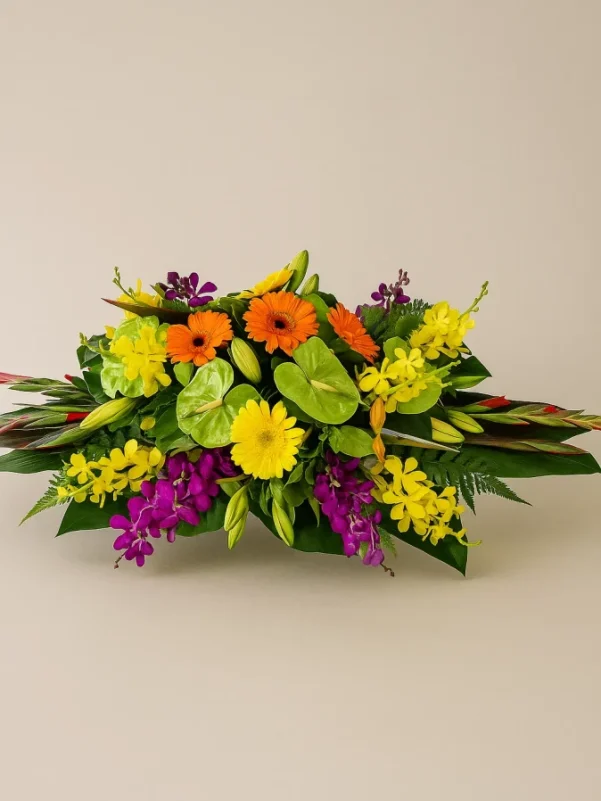 Flower centrepiece Gold Coast with bright colourful seasonal flowers in a low table arrangement