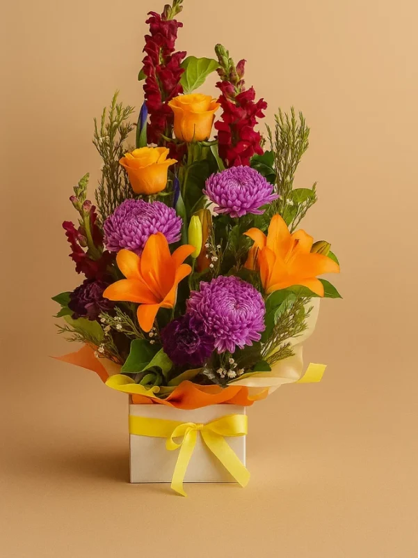 Bright flower arrangement Gold Coast with colourful seasonal flowers in container