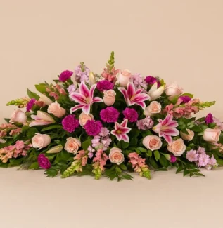 Pink casket spray with lilies and roses funeral flowers Gold Coast