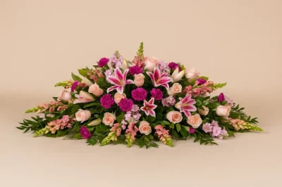 Pink casket spray with lilies and roses funeral flowers Gold Coast