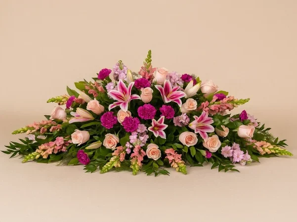 Pink casket spray with lilies and roses funeral flowers Gold Coast