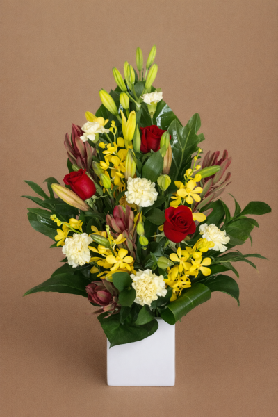 Diano flower arrangement with red roses yellow orchids lilies in ceramic vase Gold Coast