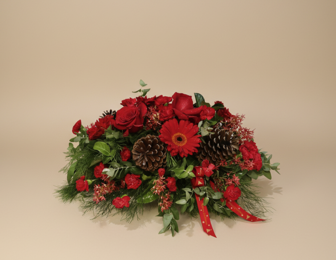 Christmas table centrepiece with red roses, gerberas, pinecones and festive foliage – Flowers of Southport