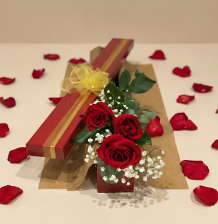 romantic rose gift box with three long stem red roses and petals on beige studio background – Flowers of Southport