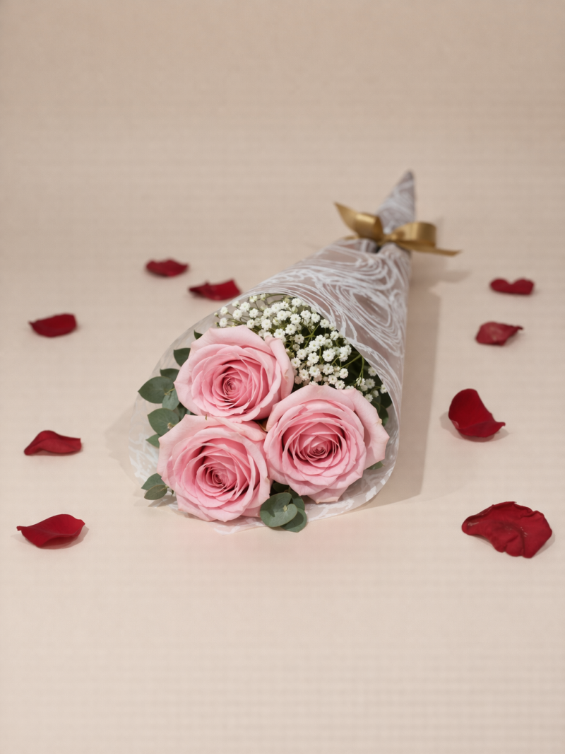 Three pink roses bouquet wrapped in elegant paper, perfect small gift on the Gold Coast