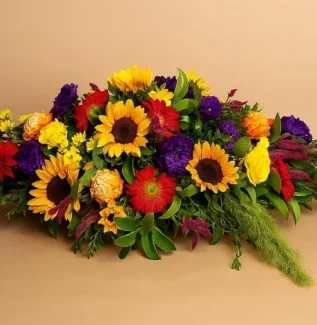 Coffin spray flowers with sunflowers and seasonal blooms Gold Coast funeral tribute