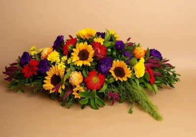 Coffin spray flowers with sunflowers and seasonal blooms Gold Coast funeral tribute