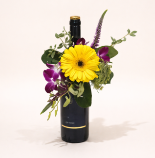 Flower arrangement with wine Gold Coast featuring fresh seasonal flowers and a bottle gift