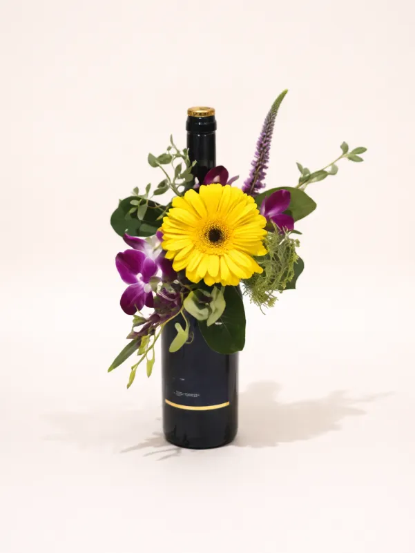 Flower arrangement with wine Gold Coast featuring fresh seasonal flowers and a bottle gift