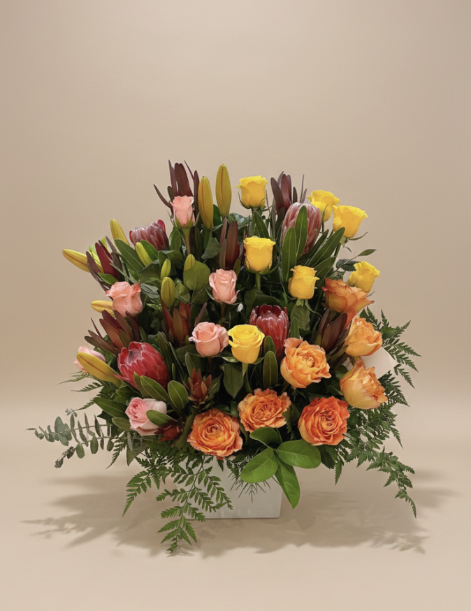 Luxury flower arrangement with yellow, peach and pink roses, proteas and lilies in a grand premium design – Flowers of Southport