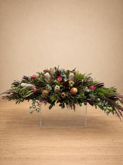 Native casket flowers with protea and banksia arranged as a funeral spray