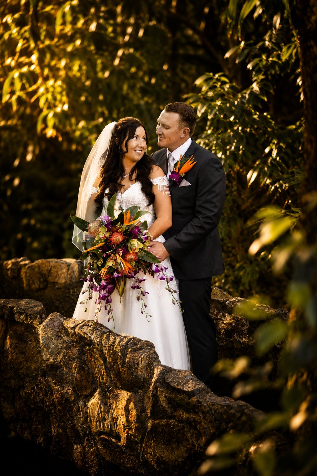 Bride and groom on a stone bridge in the Mount Tamborine rainforest — Gold Coast wedding florist