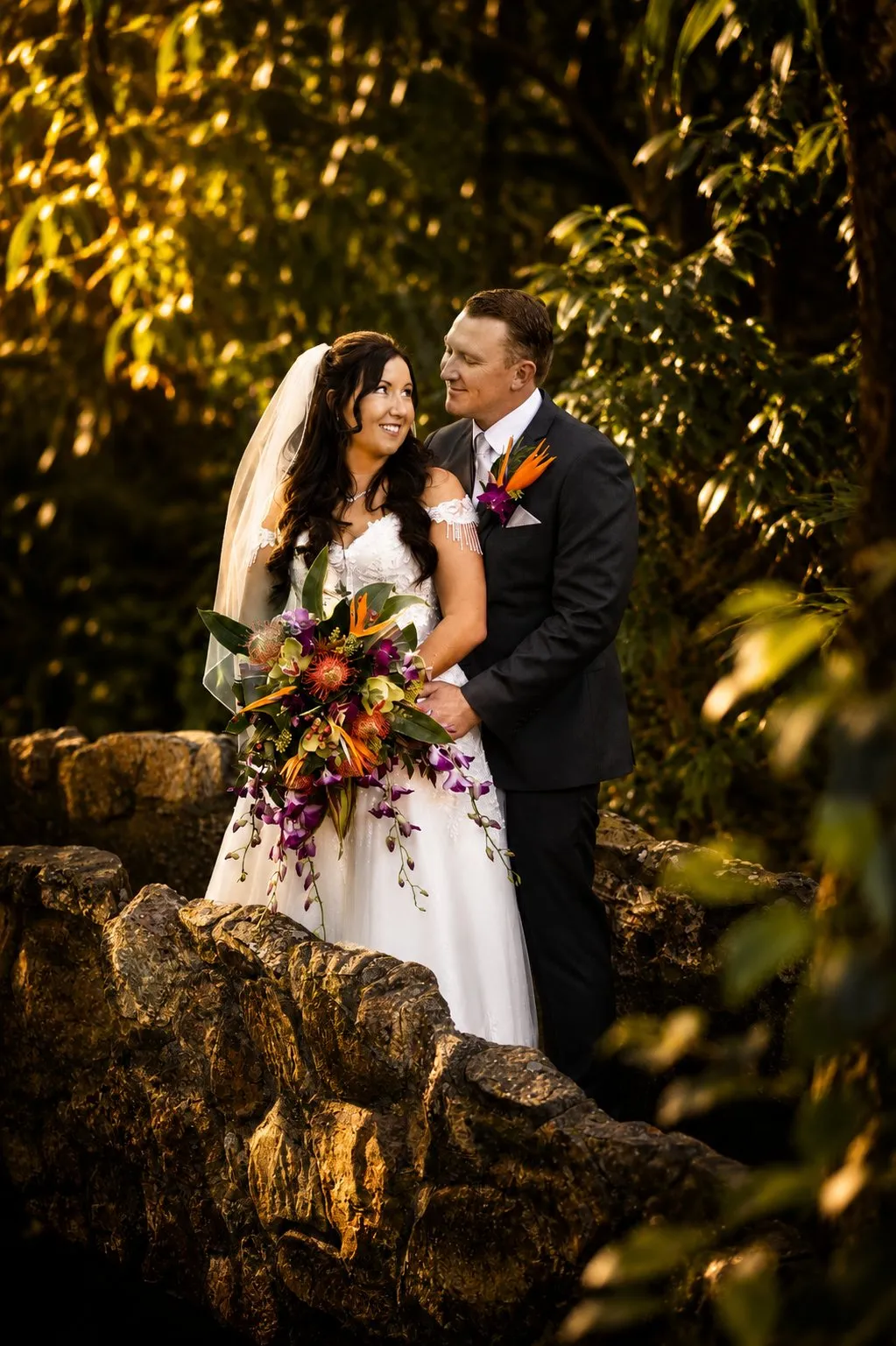 Bride and groom on a stone bridge in the Mount Tamborine rainforest — Gold Coast wedding florist
