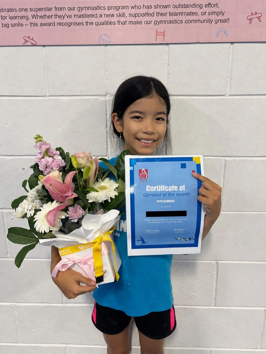 Olivia, PCYC Ashmore April Gymnast of the Month, holding her certificate and the Flowers of Southport bouquet she received.