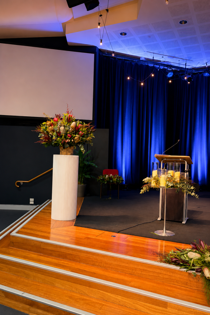Stage and podium florals at a Gold Coast conference by Flowers of Southport