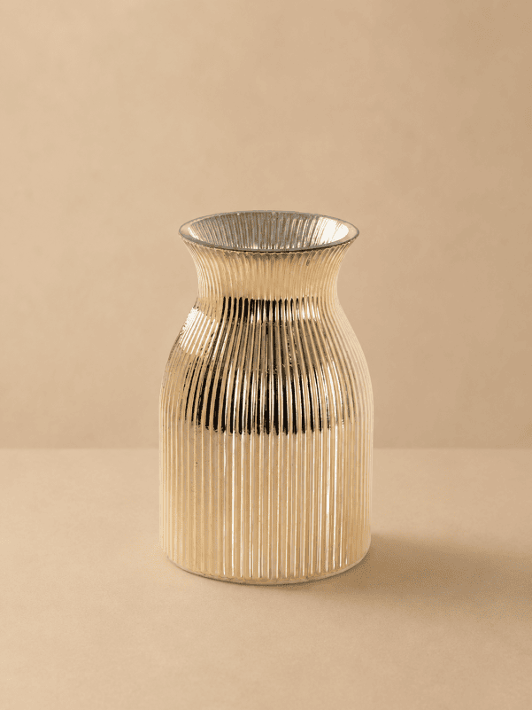 Beige ribbed glass vase with a modern fluted design on a beige background