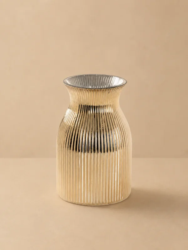 Beige ribbed glass vase with a modern fluted design on a beige background